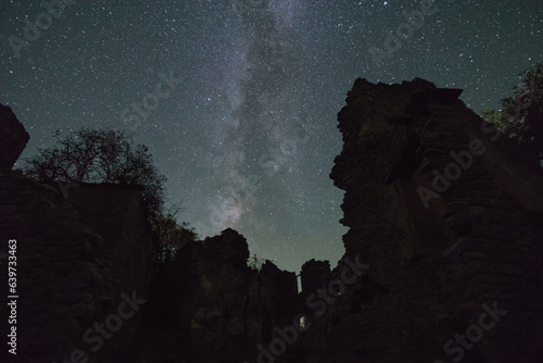The Nightsky with stars and Milky Way over ruins of ghost town of Janovas in the Pyrenees, Janovas, Aragon, Huesca, Spain