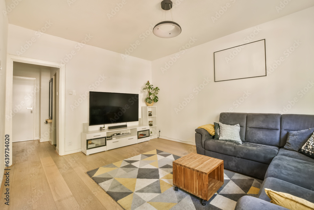 Fototapeta premium a living room with couches and a flat screen tv on the wall in front of the sofa is an entertainment center