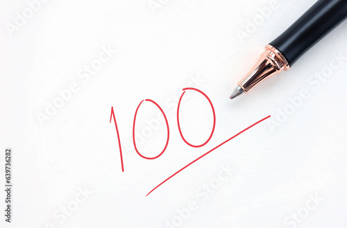 Educational concept, pen with written in red ink on white paper. full score test,red 100 full mark isolated on a white paper.