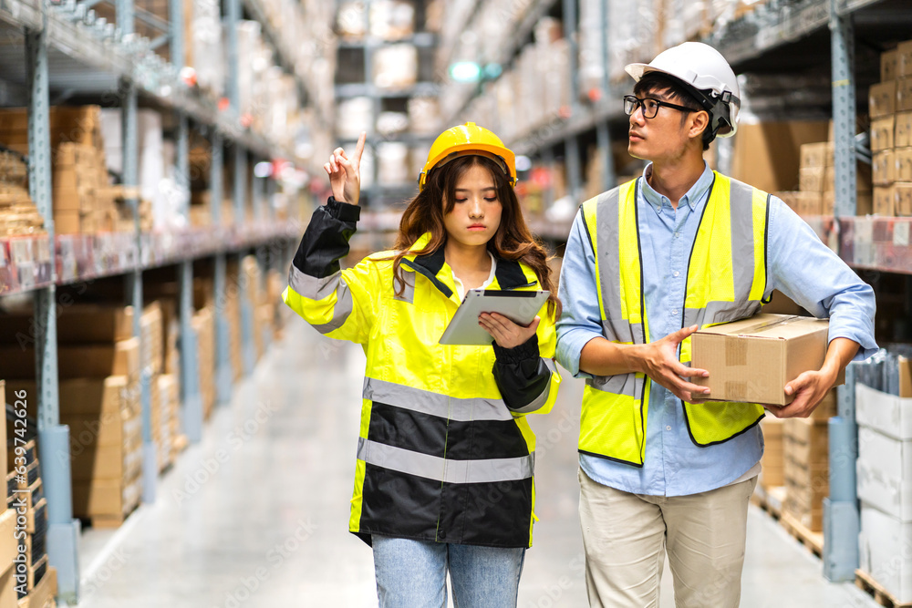 Asian two engineer team shipping order detail on tablet check goods and supplies on shelves with goods background inventory in factory warehouse.logistic industry and business export Asian two engineer team shipping order detail on tablet check goods and supplies on shelves with goods background inventory in factory warehouse.logistic industry and business export