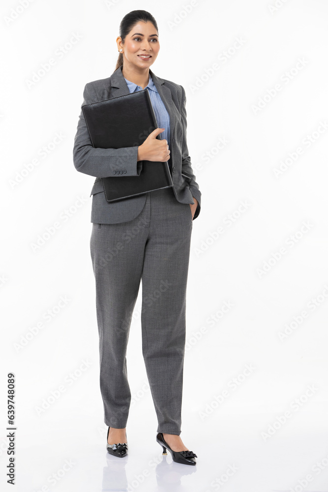 Young businesswoman holding file against white background. Young businesswoman holding file against white background.