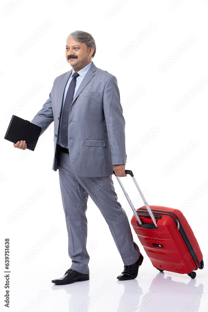 Full length of confident male professional manager with suitcase and standing against white background. Full length of confident male professional manager with suitcase and standing against white background.
