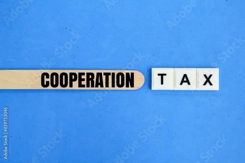 ice cream sticks and letters of the alphabet with the word Cooperation tax. tax concept for the corporate group © Fauzi