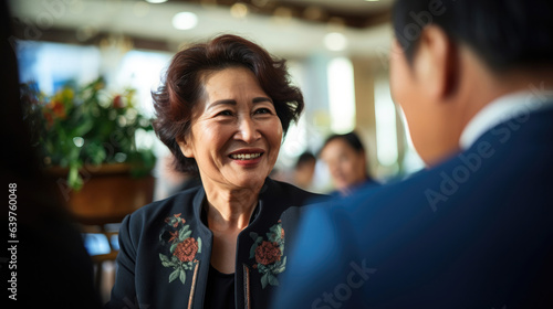 Asian businesswoman in a suit smiles to business partners