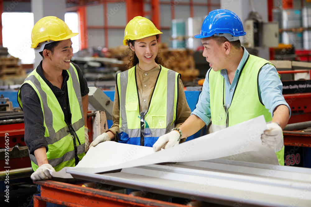 factory workers or engineers planning from work on blueprint drawing paper in the factory factory workers or engineers planning from work on blueprint drawing paper in the factory