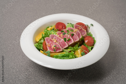 Salad with pieces of tuna on a plate