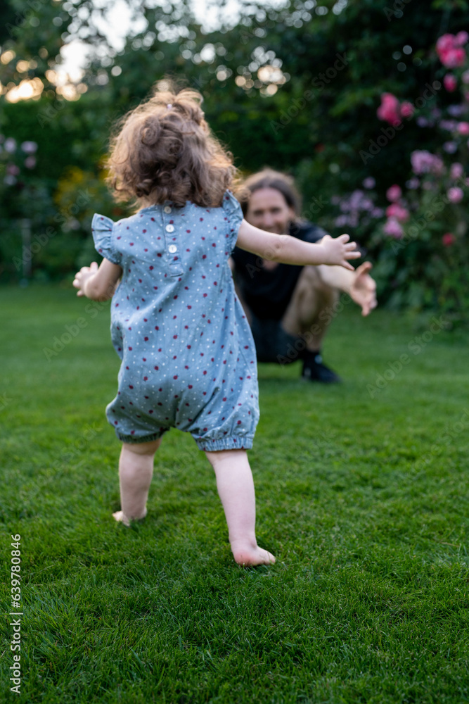 Baby learns to Wald outdoors with her dad. Baby learns to Wald outdoors with her dad.