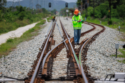 Engineer use theodolite equipment surveying construction worker on Railway site..