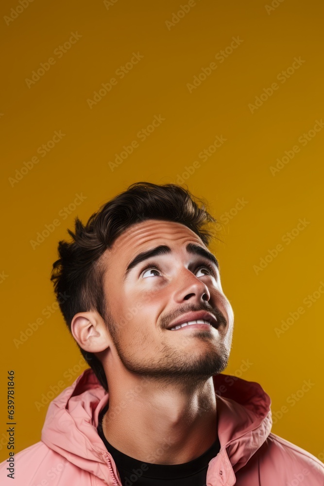 Man looking above with copy space, dirty orange background Man looking above with copy space, dirty orange background