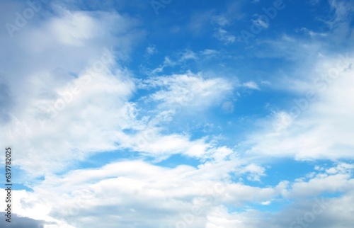 Blue sky background with tiny clouds. Nature background. Blue sky with tiny clouds.