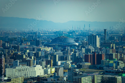 A dusk cityscape by high angle view near Kyocera dome in Osaka telephoto shot photo