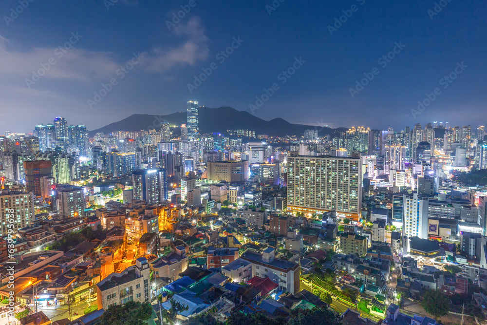 The night view of the city with buildings and villages seen from the Dong-gu Library Observatory in Busan, Korea.