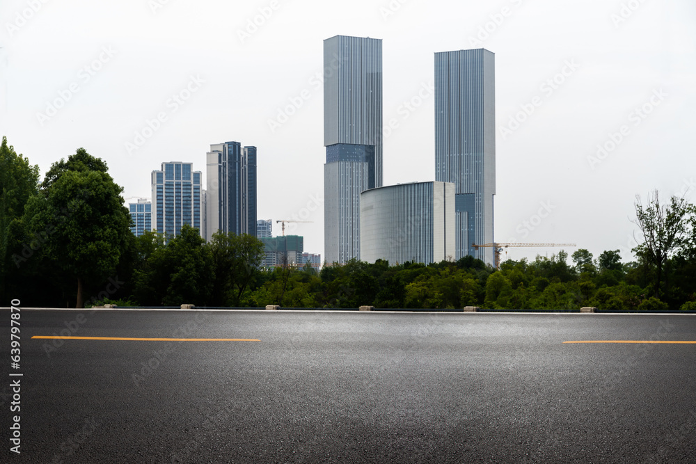 empty asphalt road in modern city with office buildings as background.
