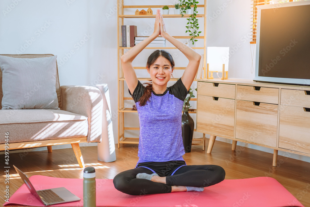 Young Asian healthy woman exercising with laptop at home Young Asian healthy woman exercising with laptop at home