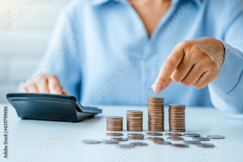 Woman save money coins whit piggy accounting for financial interest Save money for prepare in the future ,business investment concept.