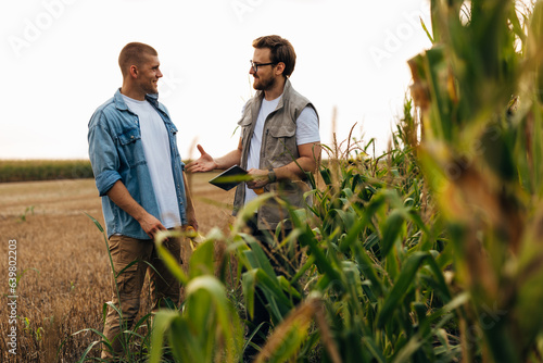 Businessman extends his hand for a handshake with a farmer.