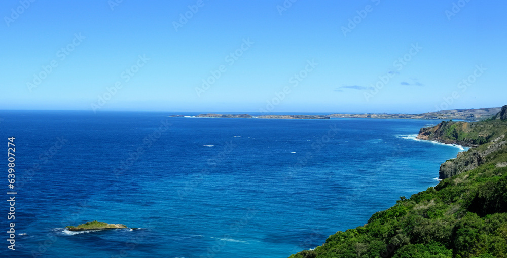 High angle view of coastline and hills calm sea