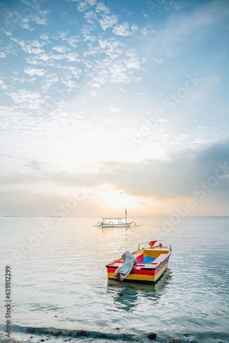 A wooden colorful traditional boat floating on the beach in the morning. Selective focus. © David