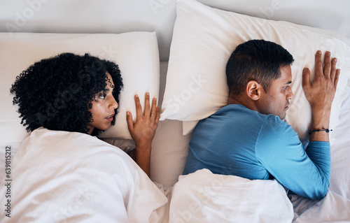 Frustrated couple, fight and lying in bed conflict, divorce or argument from disagreement or dispute at home. Top view of woman and man in breakup, cheating affair or toxic relationship in bedroom