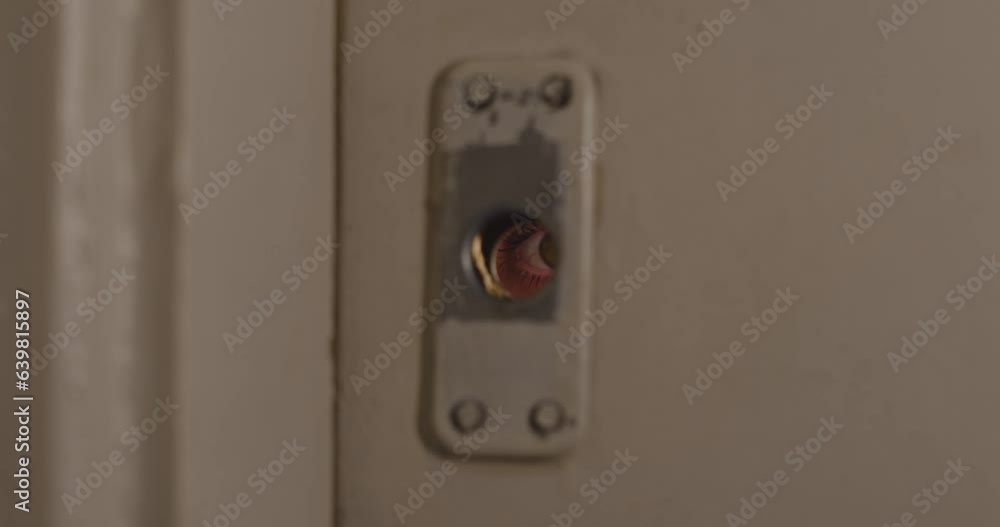 Female eye peeking through a keyhole concept for curiosity, stalker, surveillance and security Female eye peeking through a keyhole concept for curiosity, stalker, surveillance and security