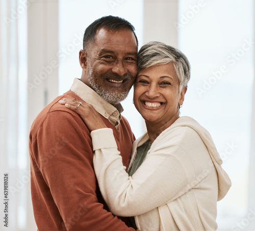 Happy, portrait and senior couple in home living room, bonding together and hug. Face smile, man and Indian woman in lounge for care, love or support for connection in healthy relationship at house © Mumtaaz D/peopleimages.com