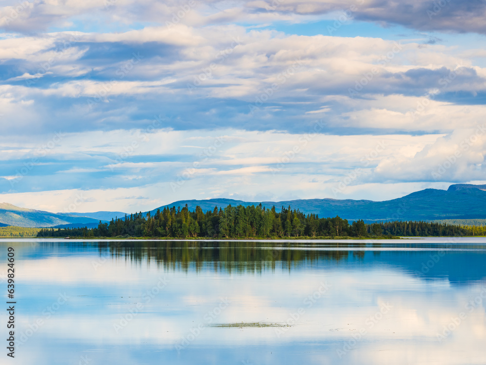 Tranquil nature scene: lake, trees, reflection, Sweden.