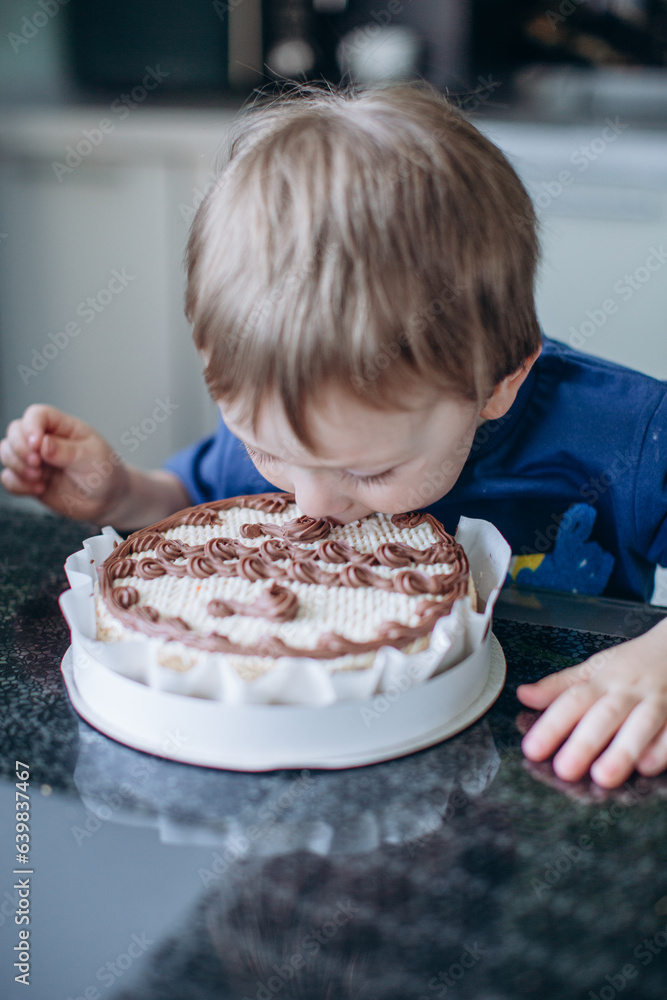little boy eating his birthday cake little boy eating his birthday cake