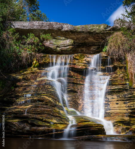 Picturesque Silky Waterfall Cascading Over Weathered Rock Formation