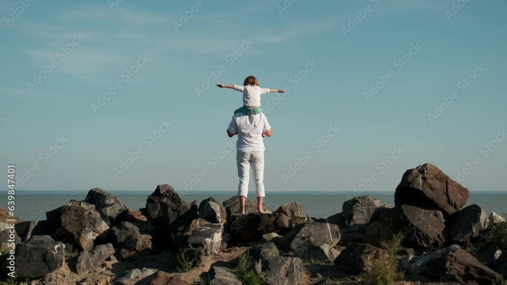 The boy imagines flying while sitting on his father's shoulders. The boy imagines flying while sitting on his father's shoulders.