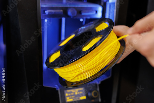 Personal 3d printer and abs or pla filament coils next to him photo