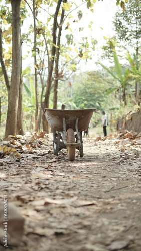 old wheelbarrow for agricultural work. An old construction trolley was abandoned in the forest