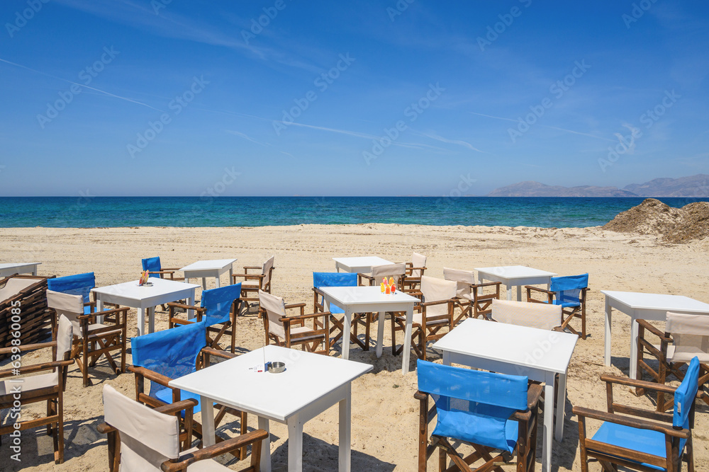 Tables and chairs on the beach in the resort town of Mastichari on the island of Kos. Greece