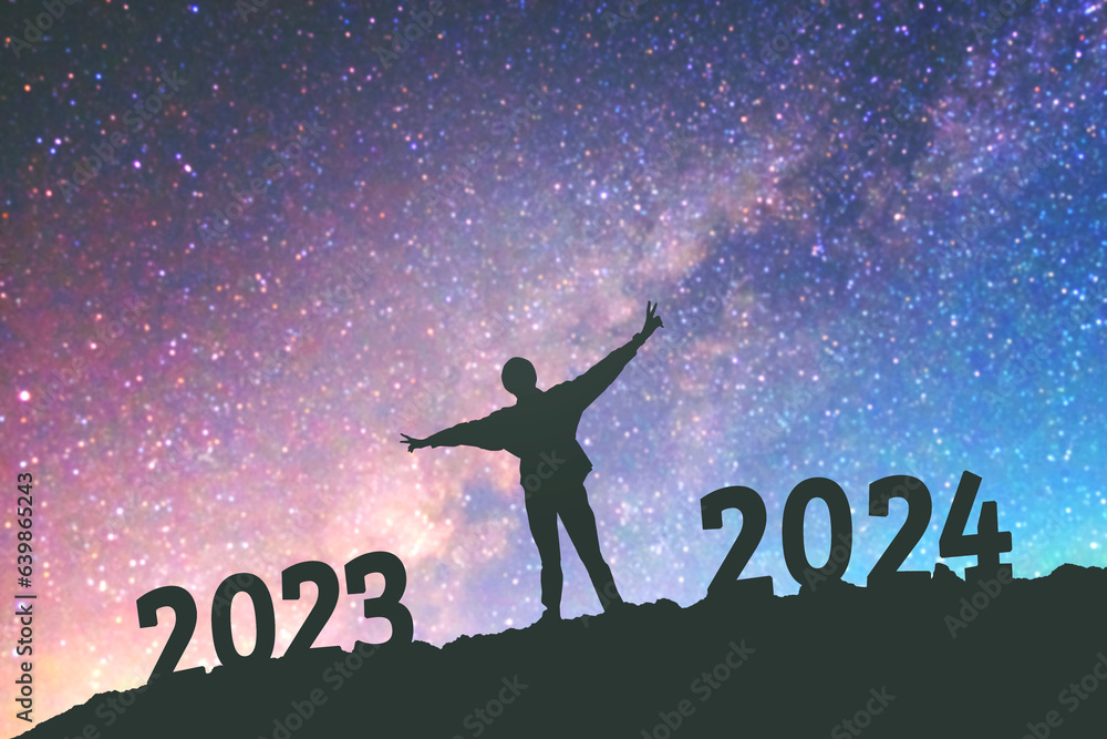 Silhouette young man Happy for 2024 new year background on  the Milky Way galaxy