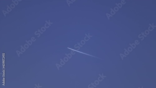 4K Video of chemtrail of airplane going through the sky leaving marks