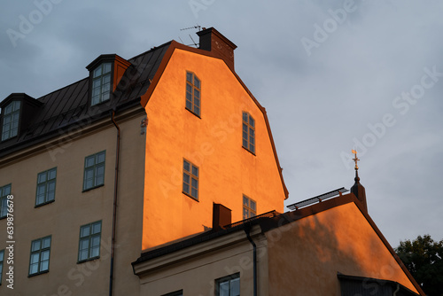 Vertical shot of a house front in Stockholm, Sweden lightened up by the evening sun