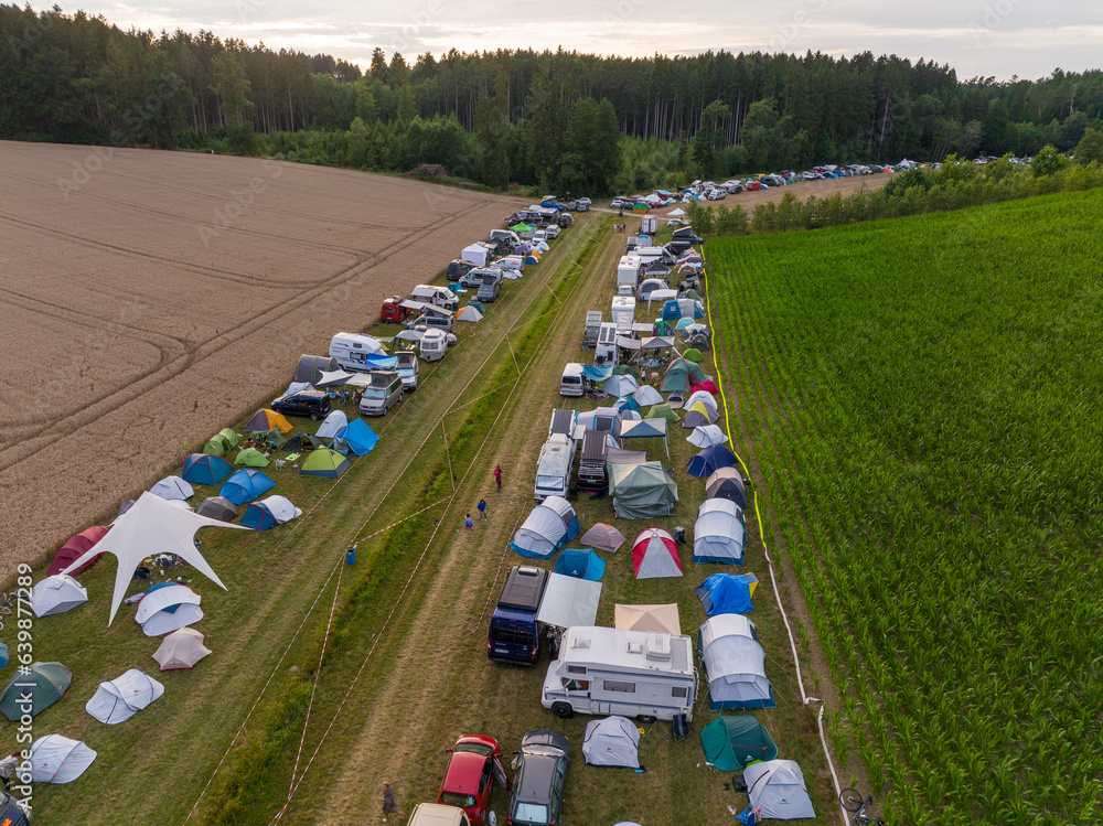 Aerial Drone Shot at Plenty of tents and Campers at a festival campsite. Camping Area Outdoors at Nature,a Open Air Fest