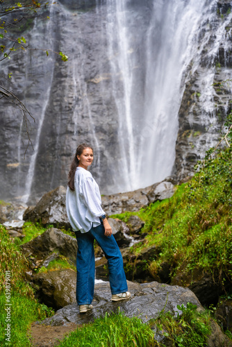 Young woman near waterfall in San Pietro town in Italy