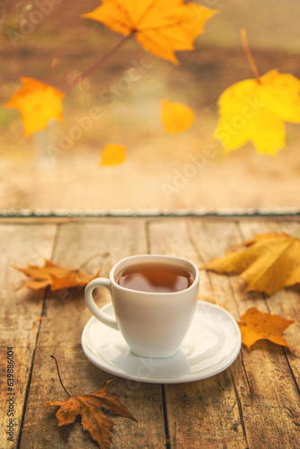 Yellow leaves a cup of autumn tea. Selective focus.