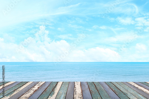 Empty wooden table for displaying products. The background is sea view, blue sky, white clouds. (with copy space) 