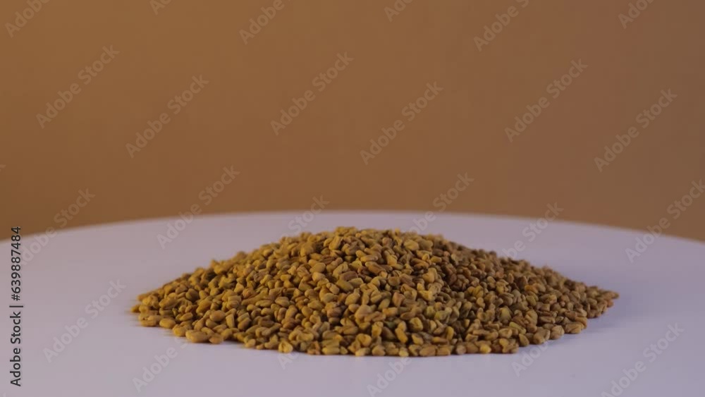 Pile of Fenugreek seeds on turntable. Selective focus. Shambhala or ...