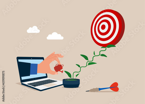 Through the laptop Businessman watering seedling growing darts in flower pot plant growing up as stair. Growth step or career path. Focus on global business goals.