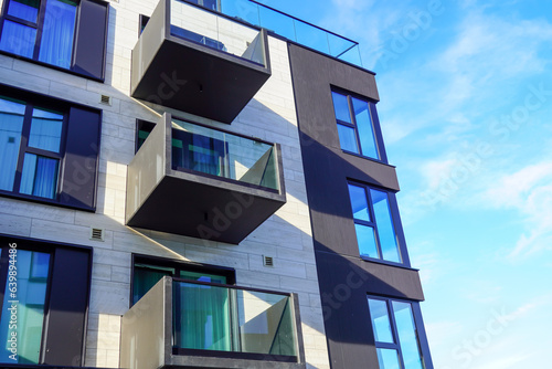 Look up to white appartment building with balconies towards blue sky. Kalamaja, Tallinn, Estonia