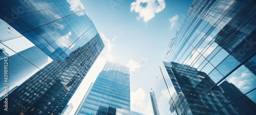 Modern office building with blue sky  and glass facades. Economy  finances  business activity concept  Bottom-up view  blurred image
