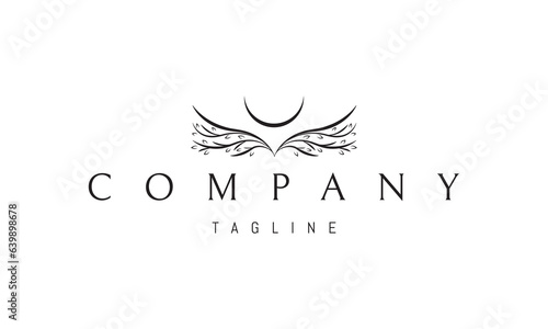 Vector logo on which an abstract image of wings from branches with leaves and the moon.
