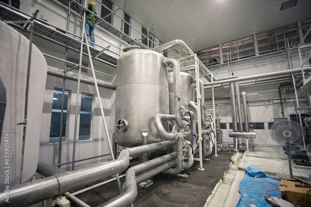 Stainless vertical tanks and pipe whites and pipes with pressure meter in equipment tank chemical cellar at the with stainless steel Stainless vertical tanks and pipe whites and pipes with pressure meter in equipment tank chemical cellar at the with stainless steel