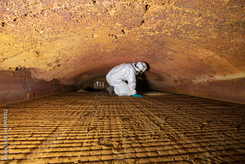 Fotografie Male worker inspecting belt refractory bricks of coil heater gas equipment of boiler room