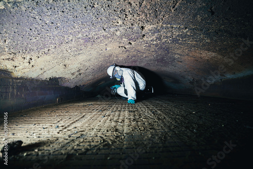Fotografie Male worker inspecting belt refractory bricks of coil heater gas equipment of boiler room