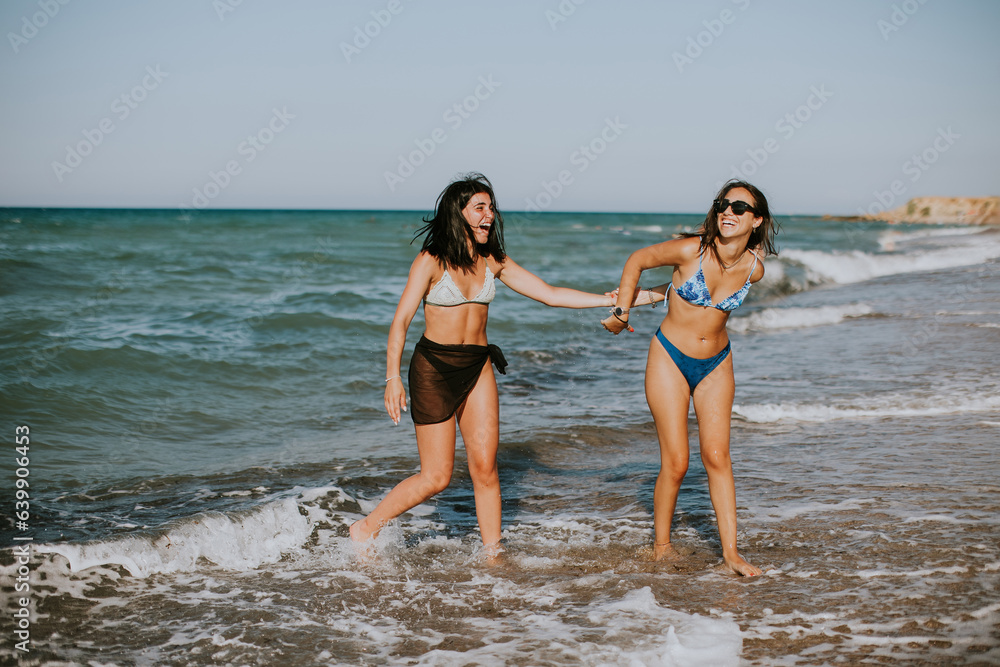 Two pretty young woman having fun on the seaside