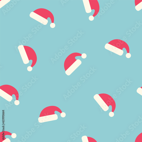 Seamless pattern with Santa Claus hats on a blue background. winter vector illustration.