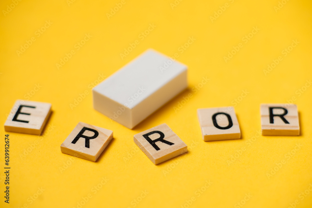 A word made of letters - error and eraser on a yellow background. A word made of letters - error and eraser on a yellow background.